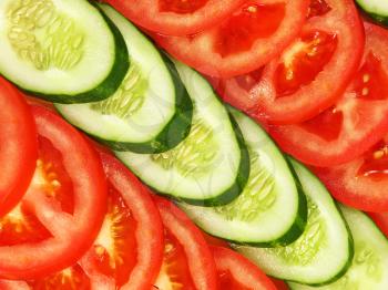 Slices of tomato and cucumber arranged in a row as background.