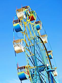 Colorful carousel against of the summer blue sky.