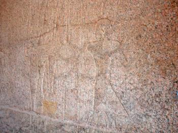 Granite wall in the Karnak temple with ancient images.