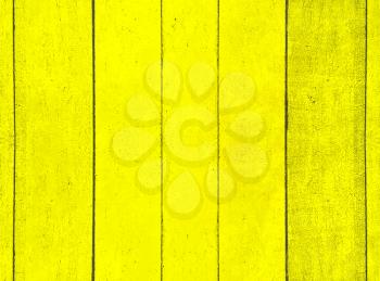 Grunge yellow wooden fence as abstract background.