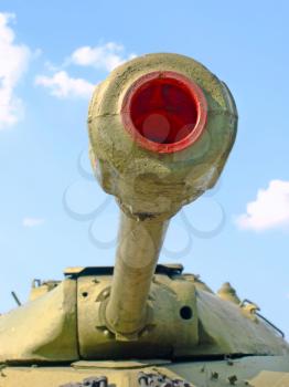 Military tank cannon against of the blue sky taken closeup.