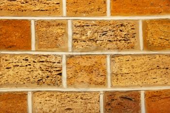Yellow and orange shell limestone brick wall taken closeup as abstract background.