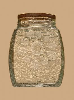 Golden glass jar on beige background.Digitally generated image.