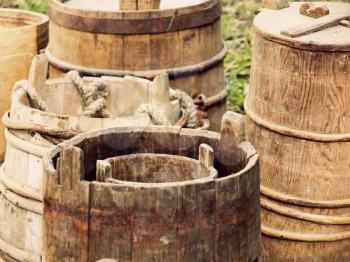 A lot of old wooden buckets and barrels taken closeup.Toned image.