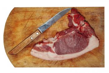 Raw pork meat and knife on wooden cutting board.Isolated.Top view.