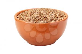 Buckwheat in brown ceramic bowl isolated on white background.