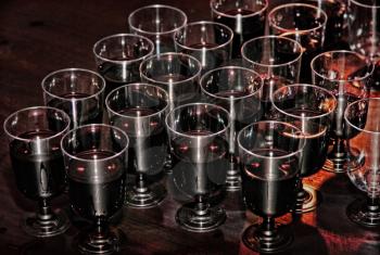 Red wine in glasses on holiday reception table.Toned image.