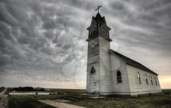 Storm Clouds Saskatchewan with old wooden church in foreground