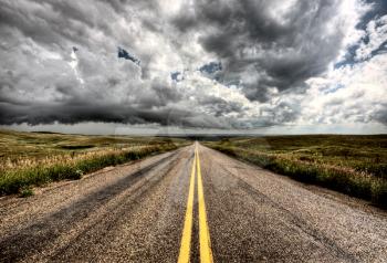 Storm Clouds Saskatchewan billowing clouds an dpaved  road