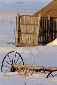 Old Barn and Wagon Wheel in Winter Saskatchewan