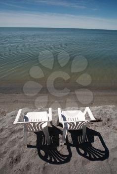 lawn chairs on beach of Lake Winnipeg