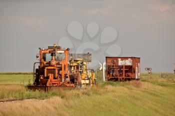 Work and ore rail cars parked on unused railroad tracks