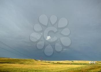 Storm clouds behind power lines in Saskatchewan