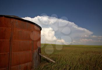 Wooden granary with Cumuloninumbus clouds in background