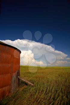 Wooden granary with Cumuloninumbus clouds in background