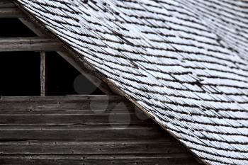 Roof on wooden barn in winter shingles