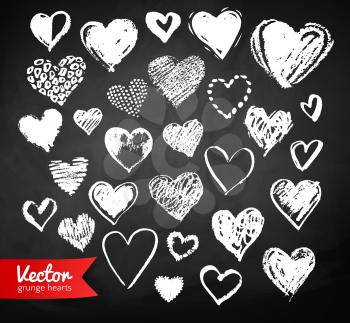 Vector white chalk drawn collection of grunge Valentine hearts on blackboard background.