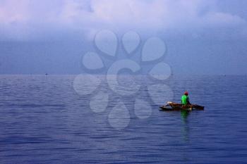 man alone  in the sea and a boat