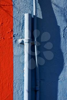 blue colored pipe and red wall in la boca  buenos aires  argentina