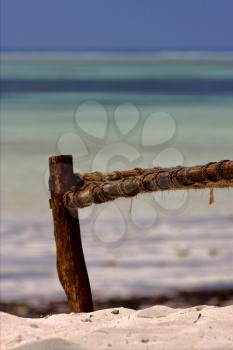 bench rope beach and sea in zanzibar coastline