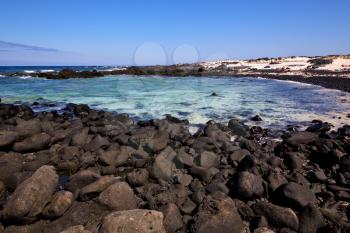 sky light  beach water  in lanzarote  isle foam rock spain landscape  stone  cloud   
