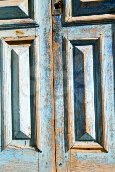 stripped paint in the blue wood door and rusty  nail