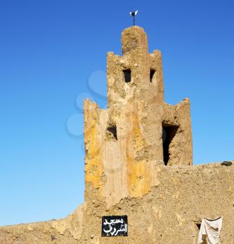 old brown construction in africa    morocco and sky  near the tower