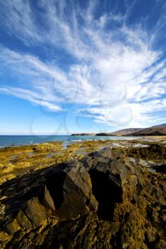 light  beach water  in lanzarote  isle foam rock spain landscape  stone sky cloud   
