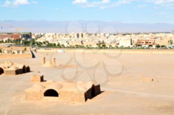 blur in iran near yazd the antique zoroastrian temple abandonated house and contruction