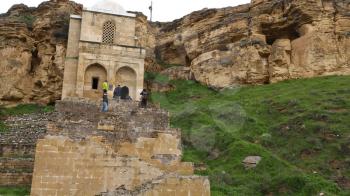 AZERBAIJAN, DIRI BABA-CIRCA MAY 2019--unidentified people near the antique mausoleum
