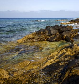 spain musk pond rock stone sky  water  coastline and summer in lanzarote 
