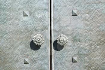  varese   abstract   rusty brass brown knocker in a  door curch  closed wood lombardy italy  sumirago