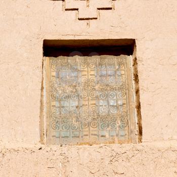 orange window in morocco africa old construction and brown wall red carpet  