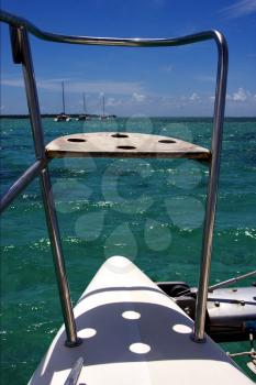 tropical lagoon hill navigable  froth cloudy  catamaran  boat  and coastline in Deer Island mauritius
