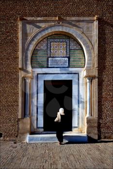 door and woman Great Mosque of Kairouan Tunisia  the fourth most sacred place of islam