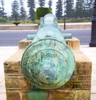 bronze cannon in africa morocco  green  and the old pavement
