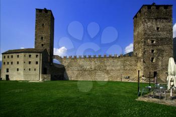 old brown castle brick and battlement in the grass of bellinzona switzerlan