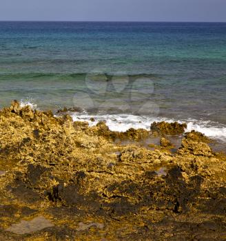  water  in lanzarote  isle foam rock spain landscape  stone sky cloud beach  
