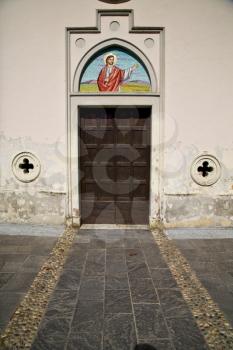  brass brown knocker and wood  door in a church abbiate varese italy