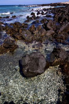  light  beach water  in lanzarote  isle foam rock spain landscape  stone sky cloud   
