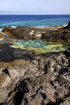 spain musk pond rock stone sky  water  coastline and summer in lanzarote 
