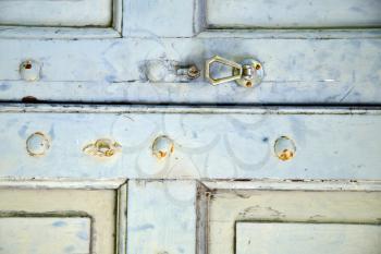 abstract cross   brass brown knocker in a   closed wood door venegono  varese italy
