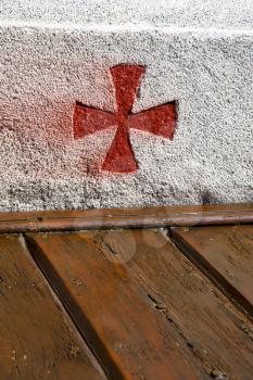 cross sumirago lombardy italy  varese abstract   wall of a curch broke brike pattern sunny day 
