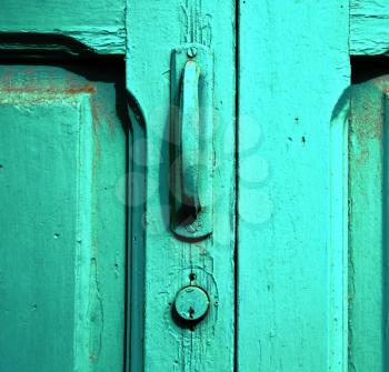 canarias brass brown knocker in a green closed wood  door  lanzarote abstract  spain 
