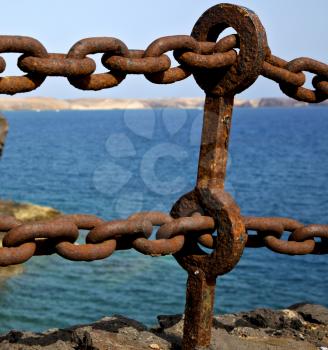 rusty chain  water  boat yacht coastline and summer in lanzarote spain
