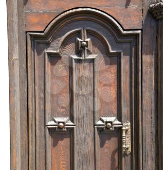 brebbia abstract   rusty brass brown knocker in a  door curch  closed wood italy  lombardy 