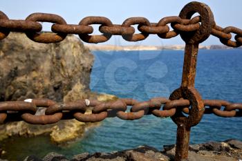 rusty chain  water  boat yacht coastline and summer in lanzarote spain
