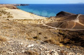 in lanzarote spain pond  rock stone sky cloud beach  water  musk  coastline and summer in lanzarote spain boat yacht
