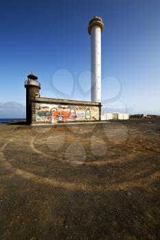 lighthouse and rock in the blue sky   arrecife teguise lanzarote spain