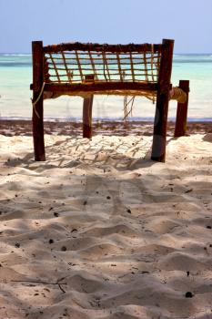 seat deck beach rope sand and sea in zanzibar coastline